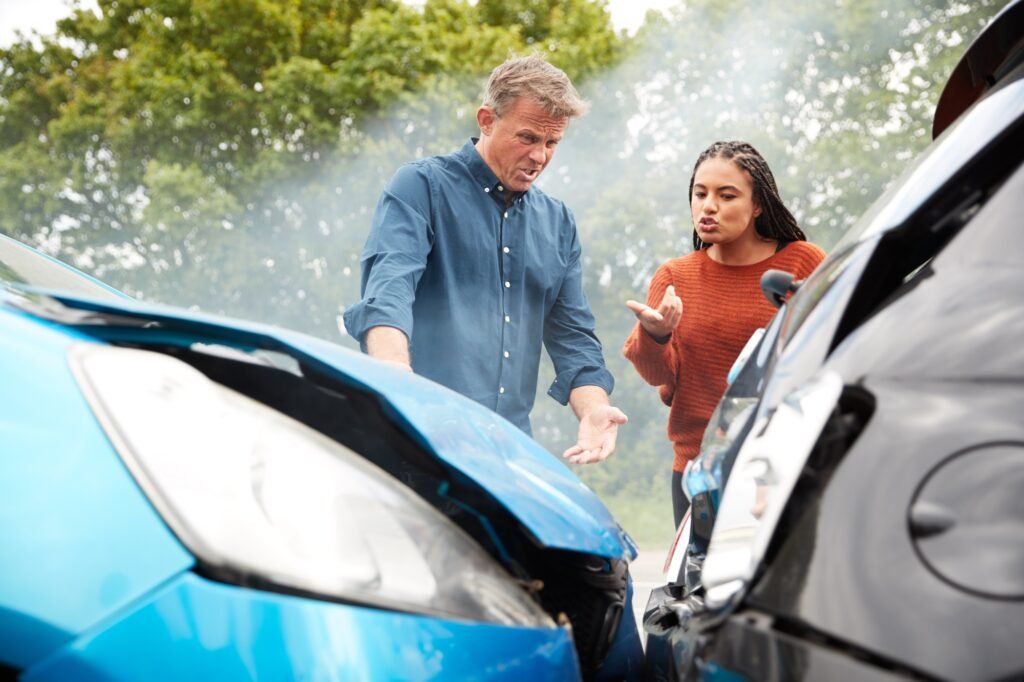 Two Angry Motorists Arguing Over Responsibility For Car Accident